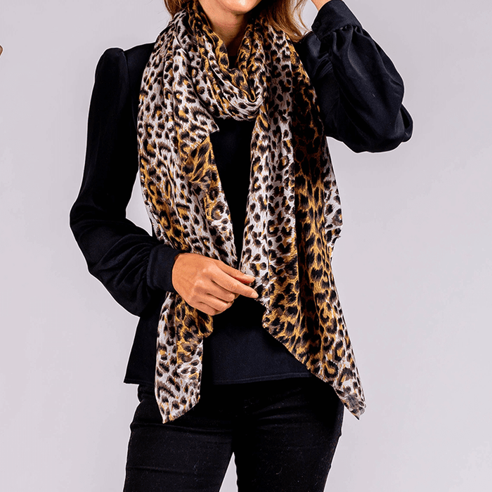 Brown leopard print fabric scarf draped around the neck of a person wearing a black long-sleeve top.